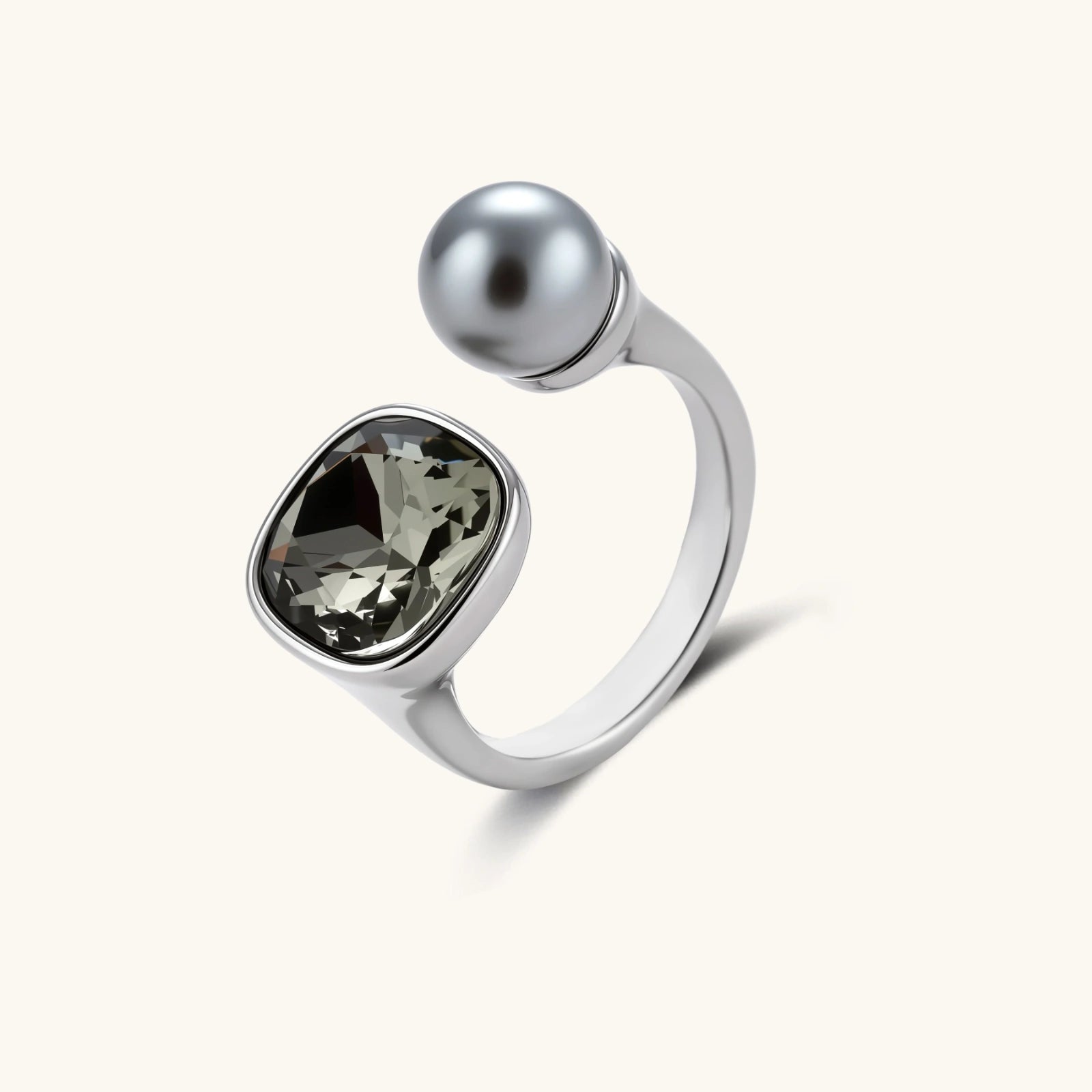 Modern adjustable ring with smoky zircon stone and metallic sphere in platinum-plated copper finish on neutral background.